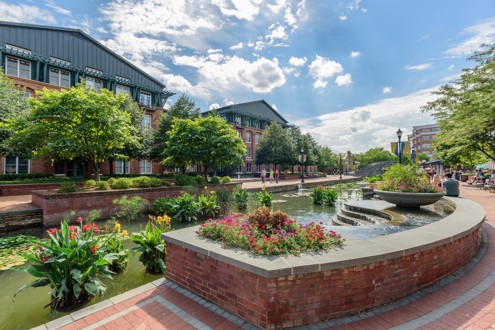 Carroll Creek Park in downtown Frederick, Maryland — brick-lined canal, flowers, red-brick buildings